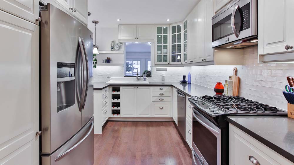 Kitchen with stainless steel appliances and white cabinets
