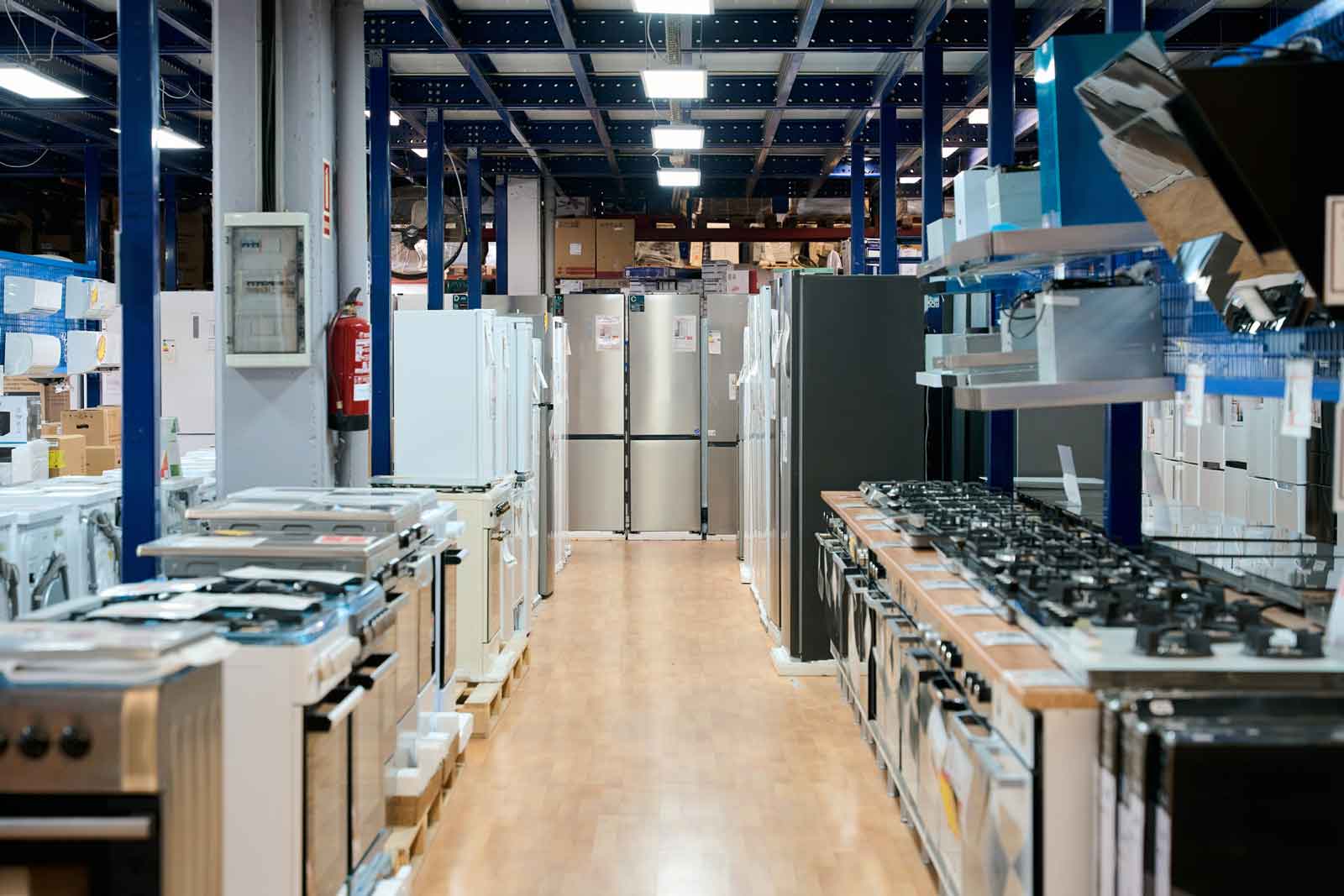Interior of appliance store. Many different models of ovens, stoves, dishwashers, and refrigerators are on display